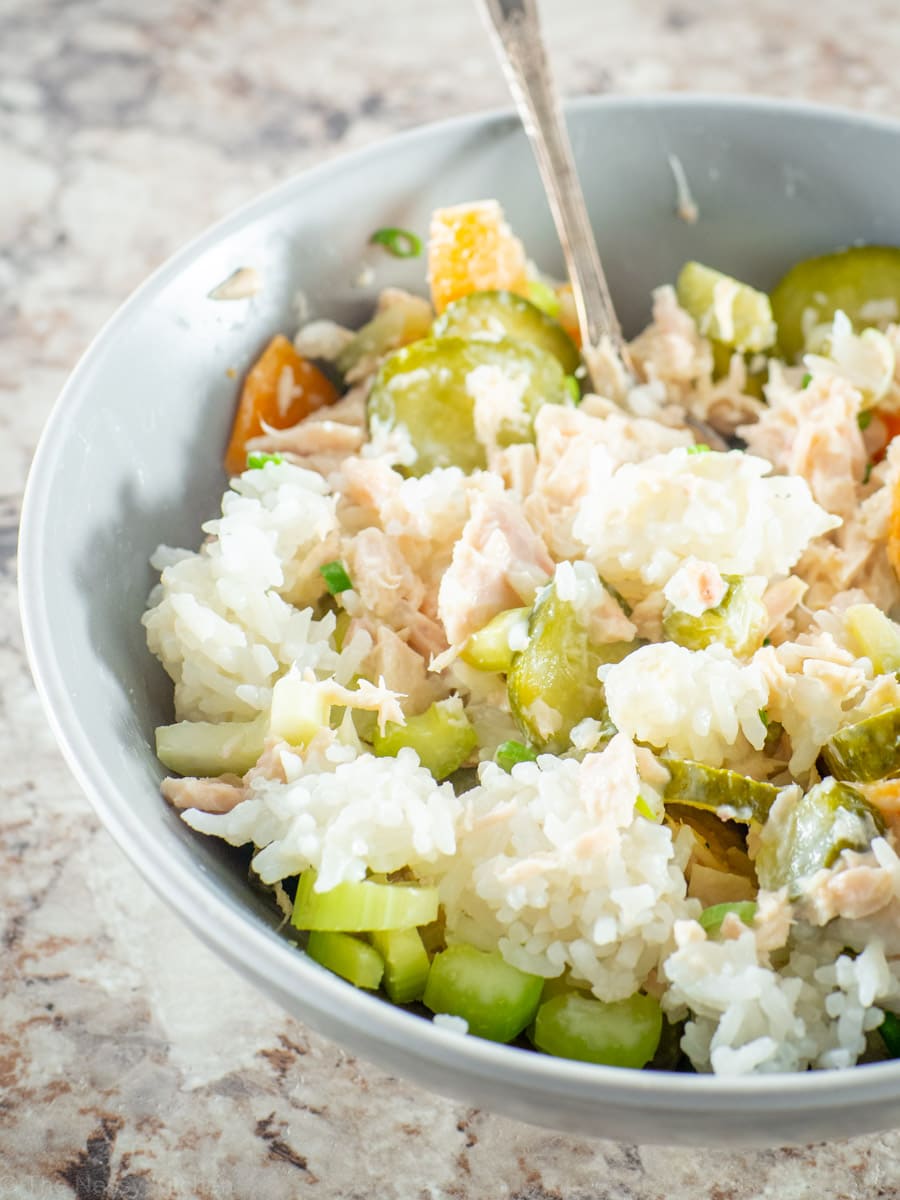 Tuna, rice and vegetables mixed together with vegetables in a bowl.