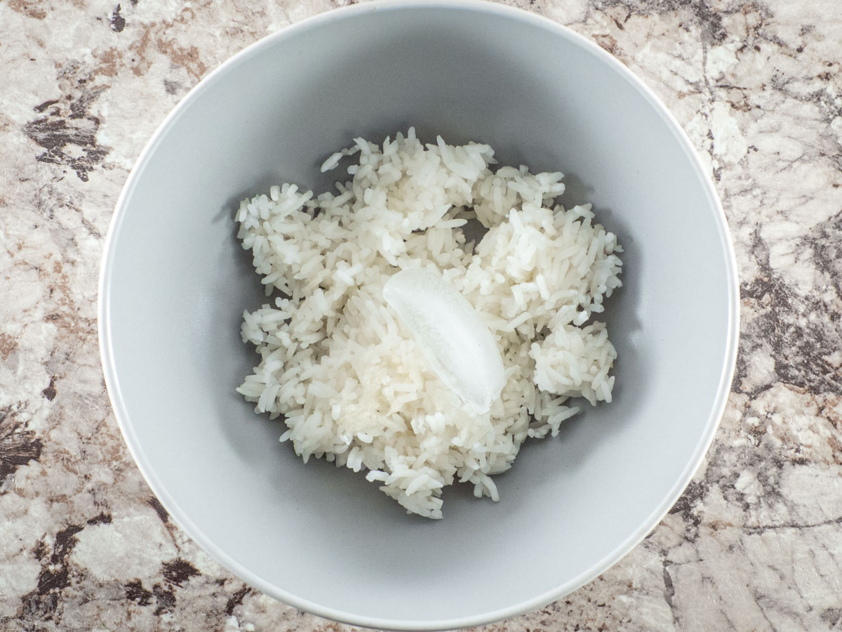 Rice in a bowl with an ice cube.