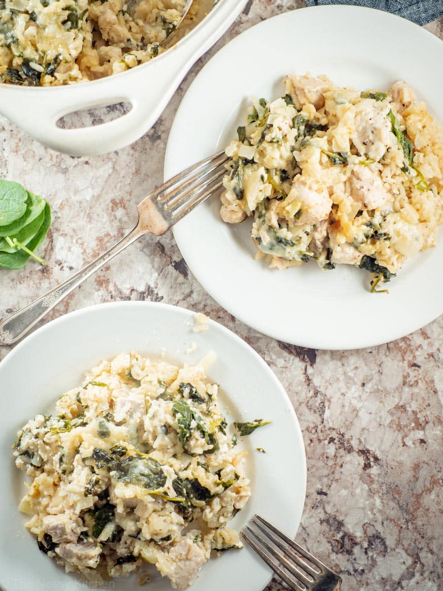 Chicken spinach and rice casserole dished out onto two plates.