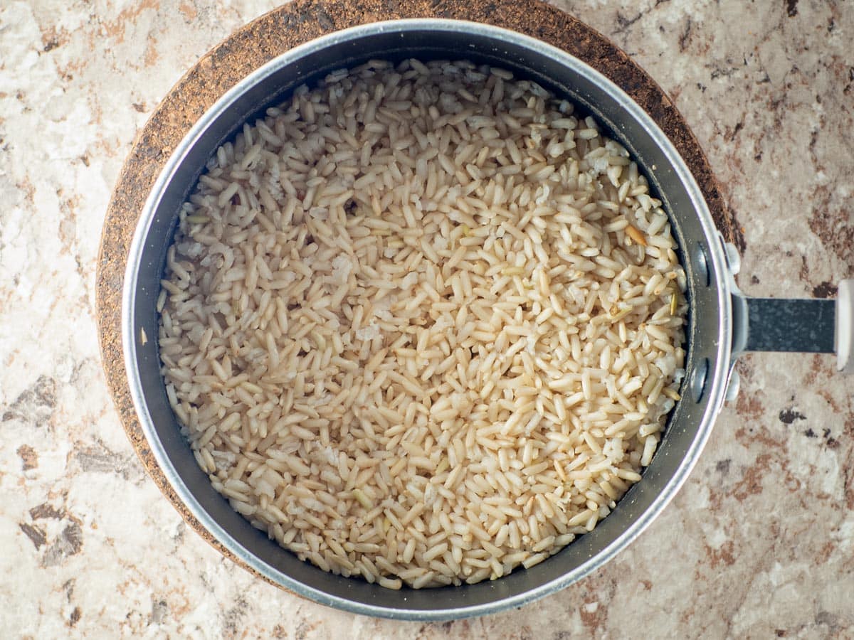 Brown rice cooked in a pot.