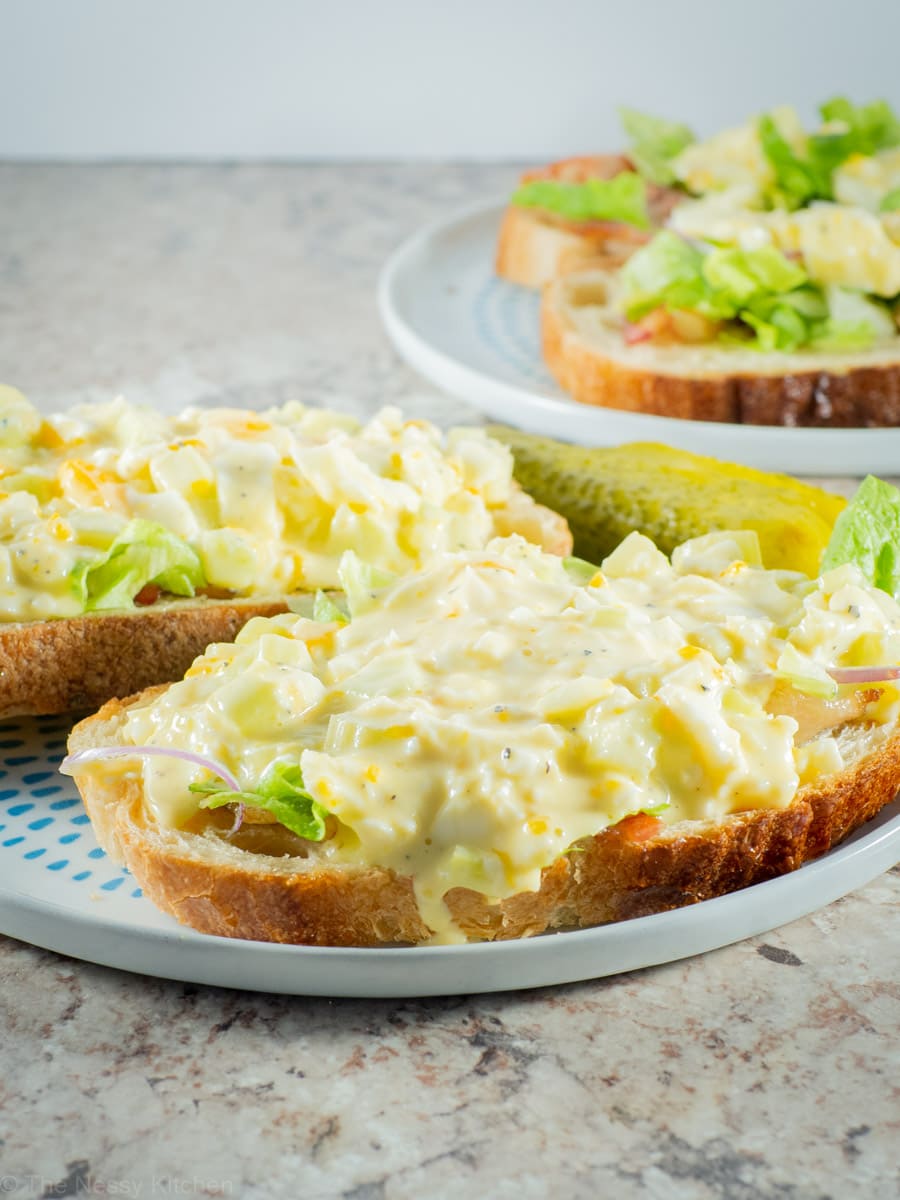 Greek yogurt egg salad as open face sandwiches on sourdough bread.