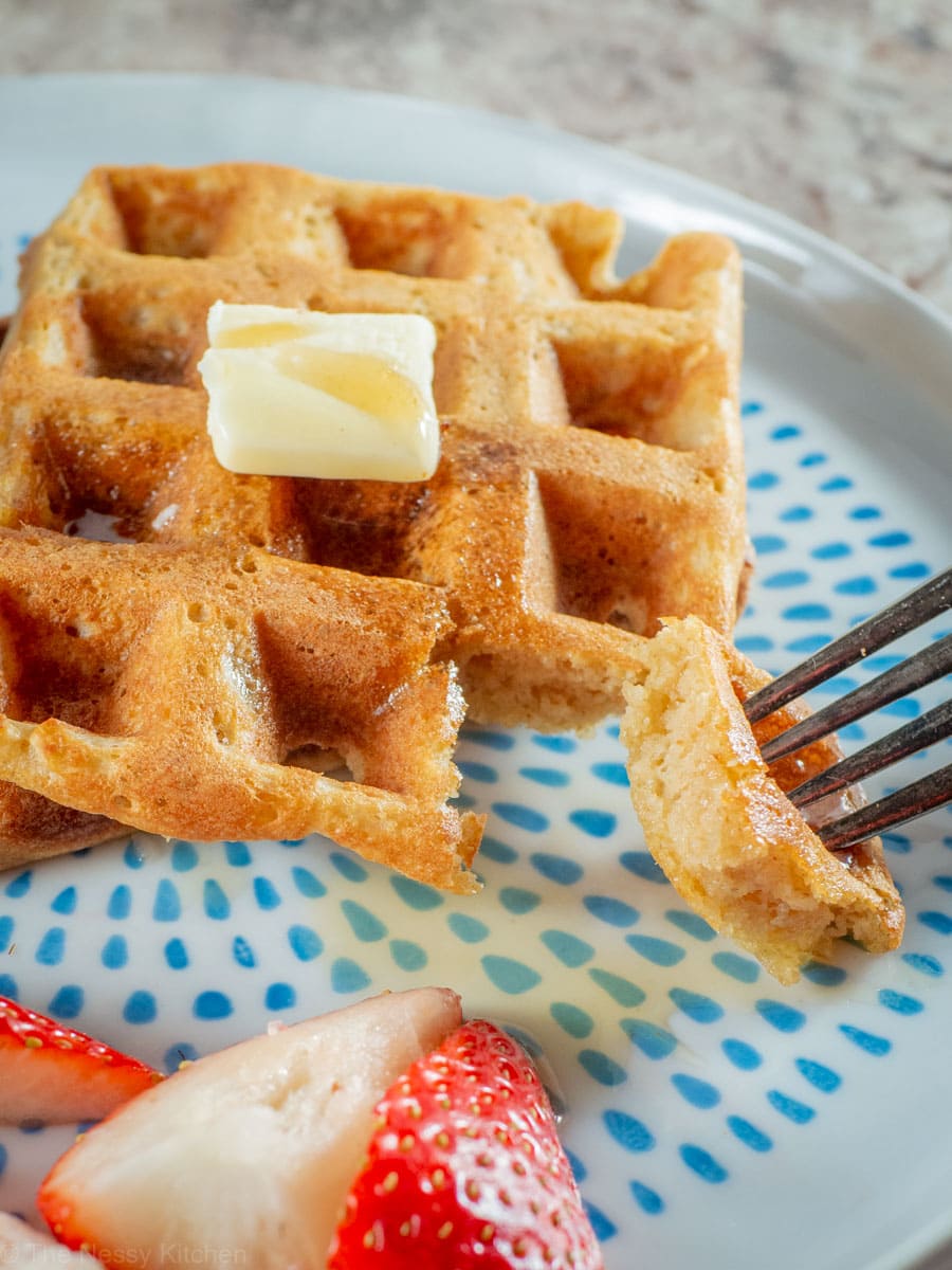 Close up shot of a bite of oat flour waffles showing how fluffy they are.