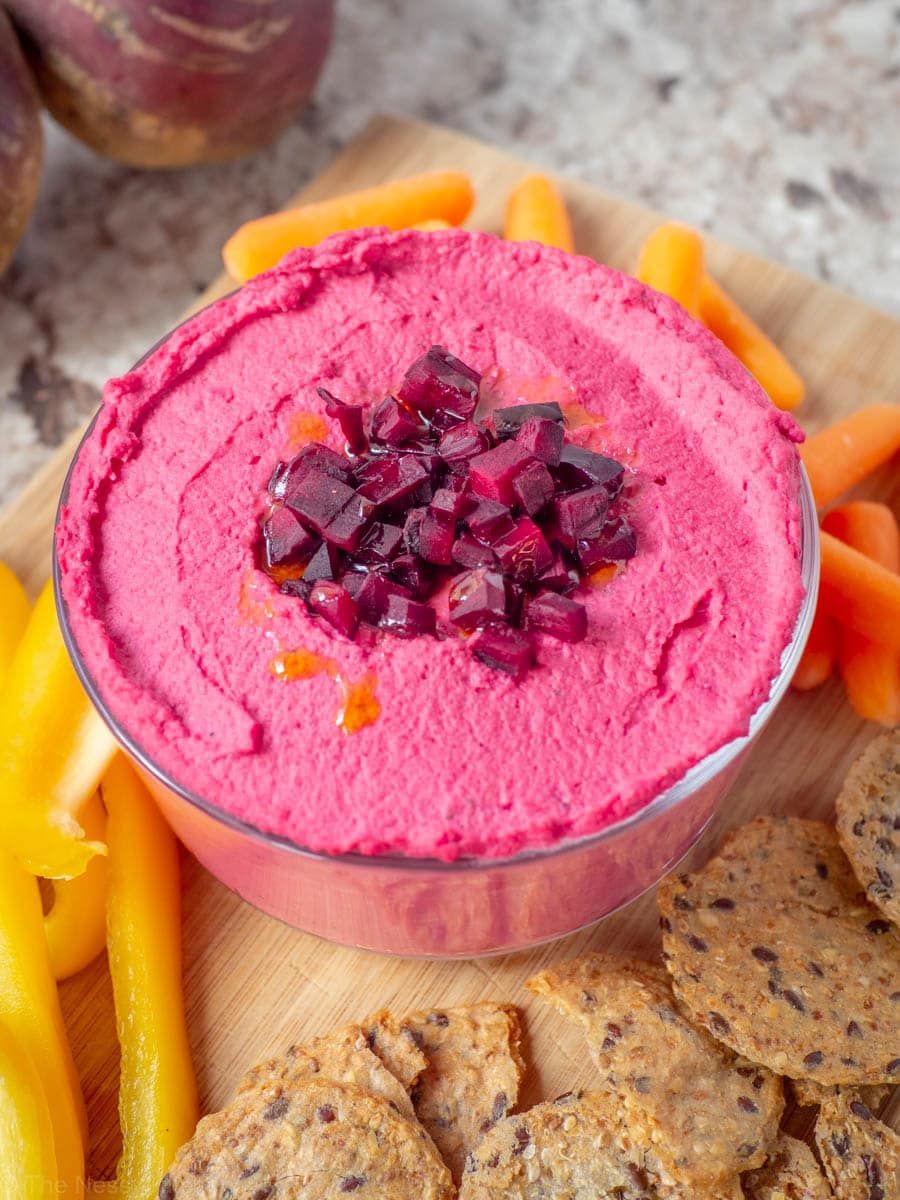 Beet hummus in a bowl topped with additional roasted beets.