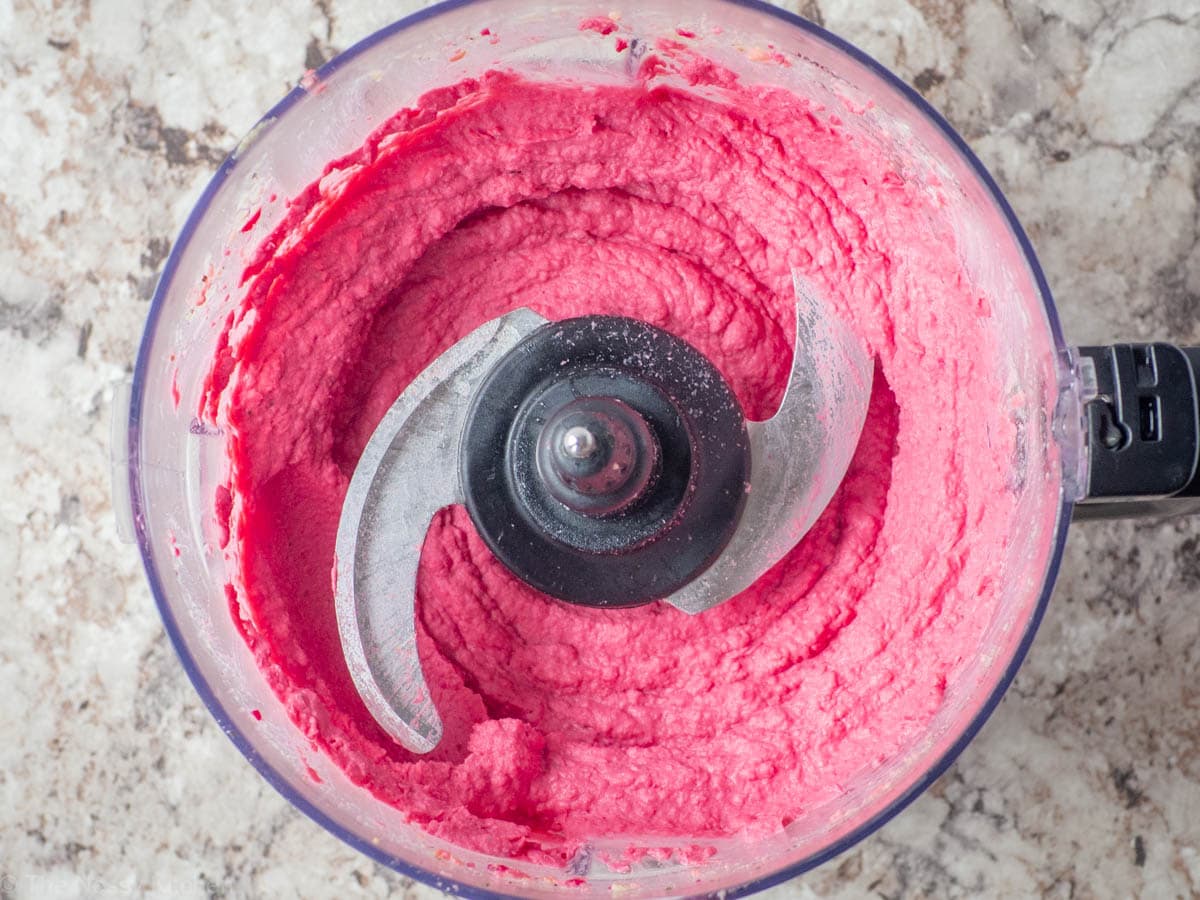 Beet hummus in the base of a food processor.