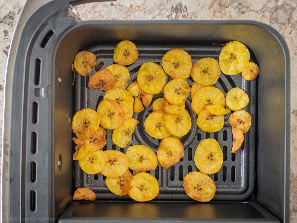 Cooked plantains in the basket of an air fryer.