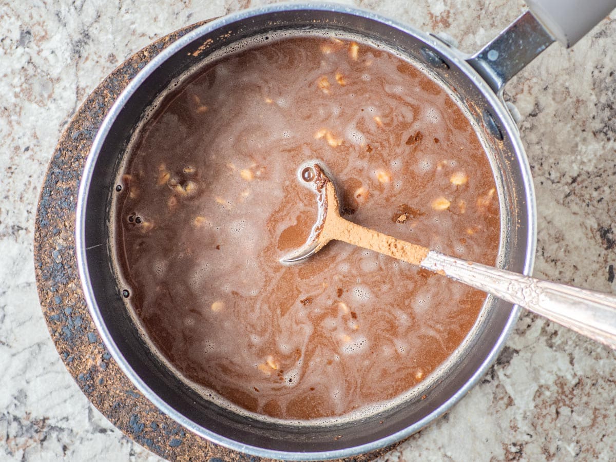 Oats and cocoa stirred into boiling water.