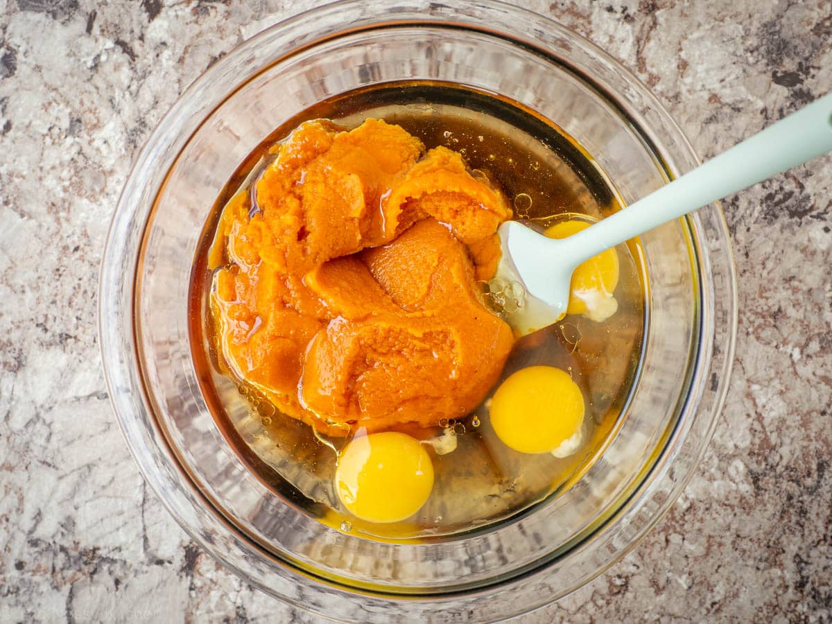 Pumpkin puree and other wet ingredients in a mixing bowl.