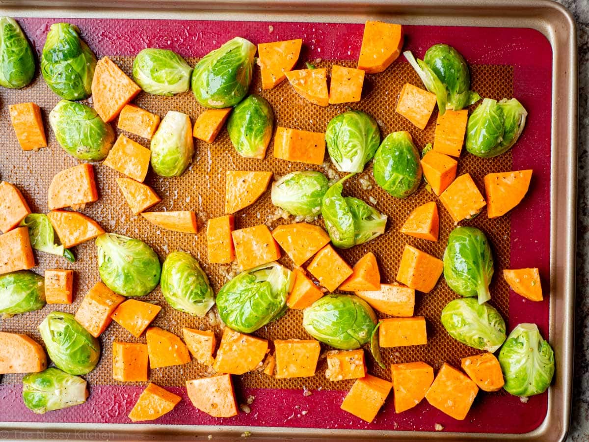 Vegetables spread out onto a sheet pan.