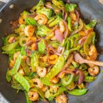 Stir fried vegetables and shrimp in a wok.