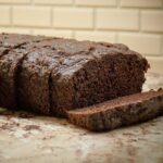 Sliced chocolate zucchini bread on a countertop.