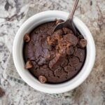 Ramekin of chocolate baked oatmeal with a spoon.
