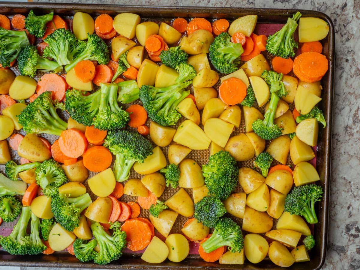 Vegetables spread out on a sheet pan.