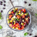 Black bean salsa in a bowl with a spoon.