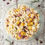 Fall pasta salad in a serving bowl with a spoon.