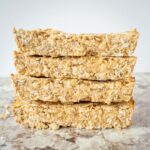 Stack of protein granola bars on a countertop.