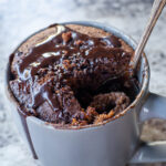 Spoon dipping into a mug of oat cake.