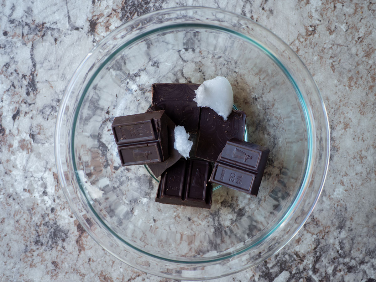 Baking chocolate chunks in a bowl with coconut oil.
