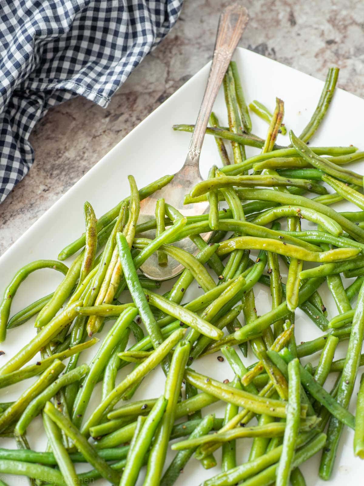 Roasted green beans on a plate.