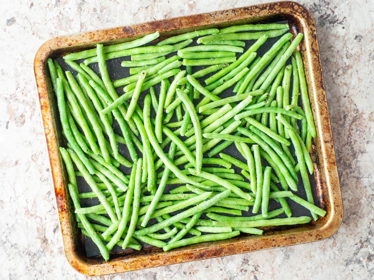 Frozen green beans on a sheet pan.