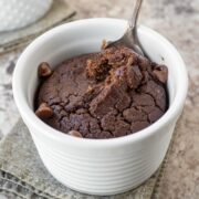 Chocolate baked oatmeal in a ramekin with a spoon.