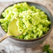 Green rice on a spoon.