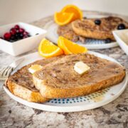 Sourdough French toast on a plate with fruit.