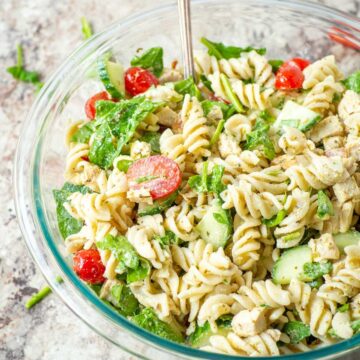 Pesto pasta salad in a large serving bowl.