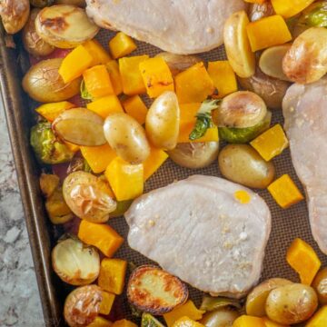 Pork chops and vegetables on a sheet pan.