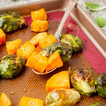 Sweet potatoes and Brussels sprouts on a spoon.