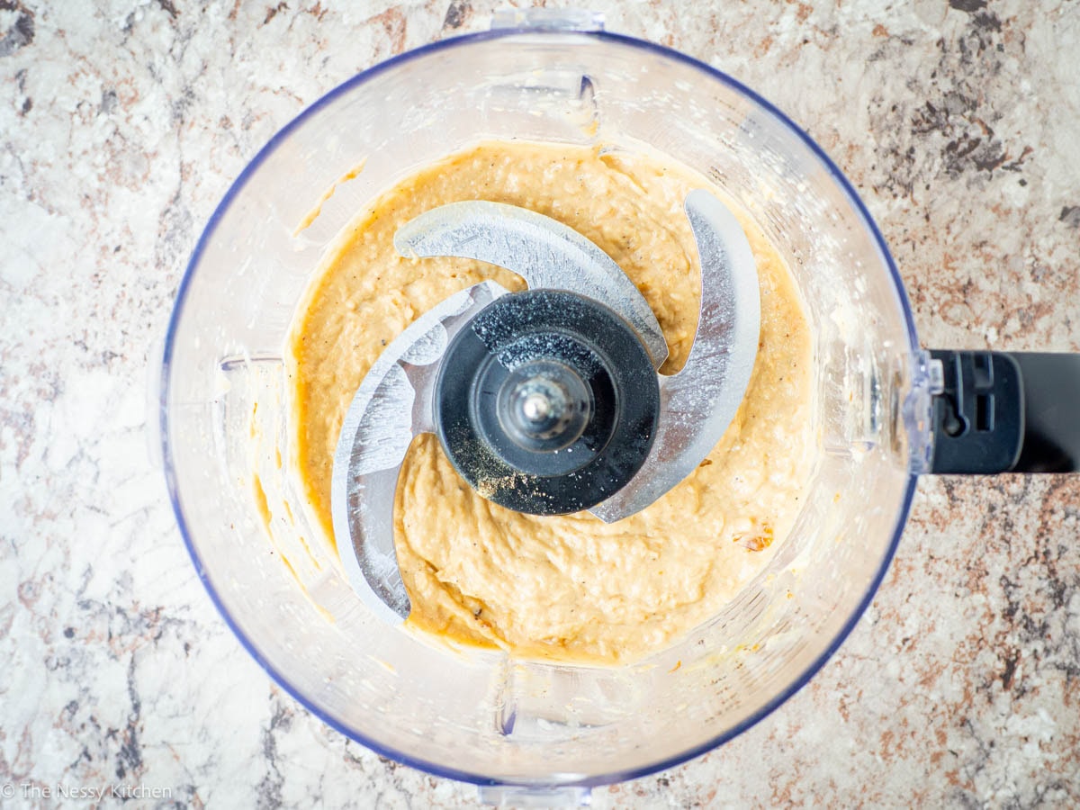 Tahini whipped in the bowl of a food processor.