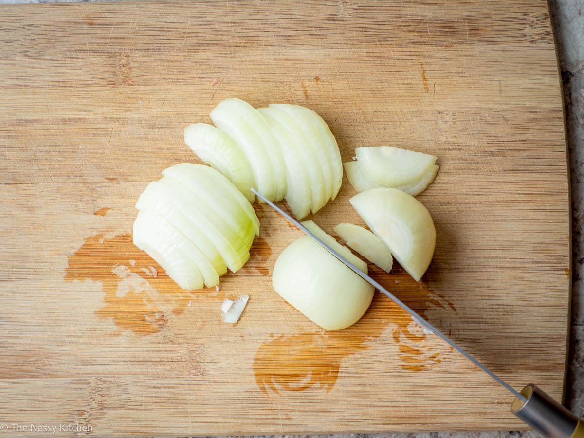 Sliced onions on a cutting board.