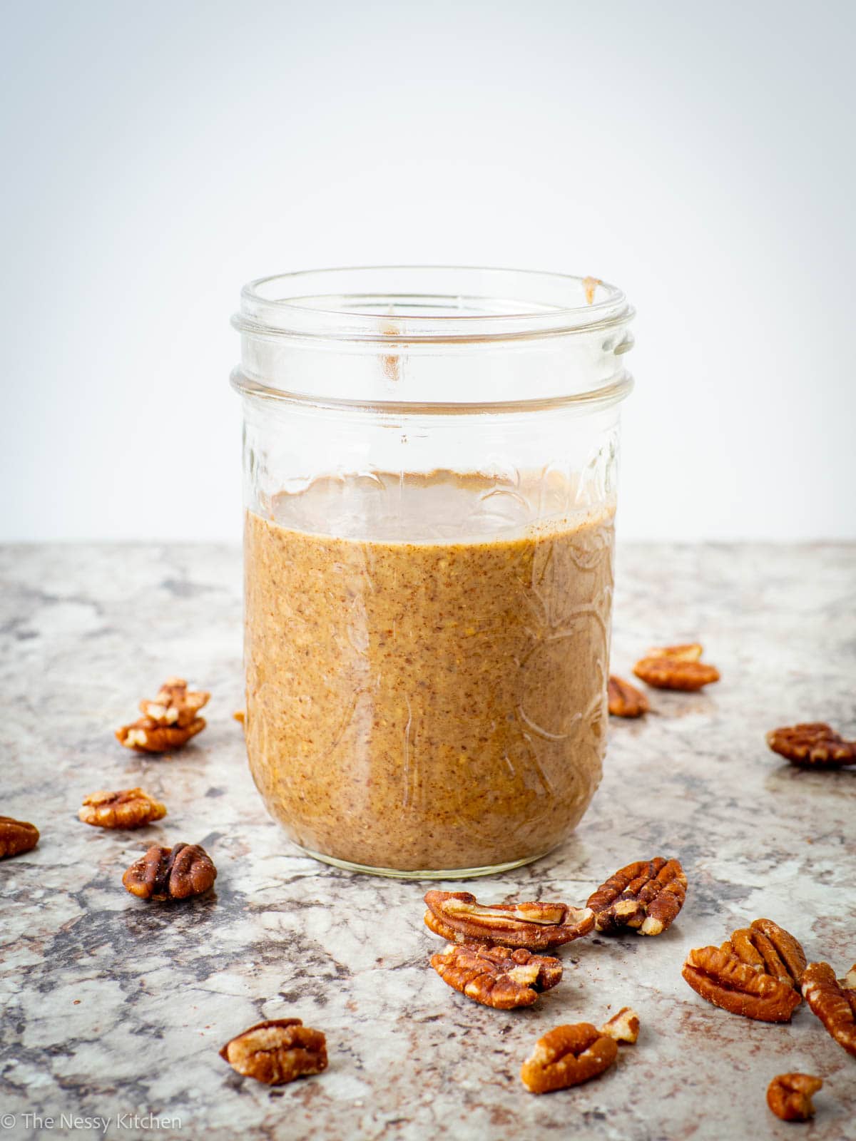 Pecan butter packaged into a jar.