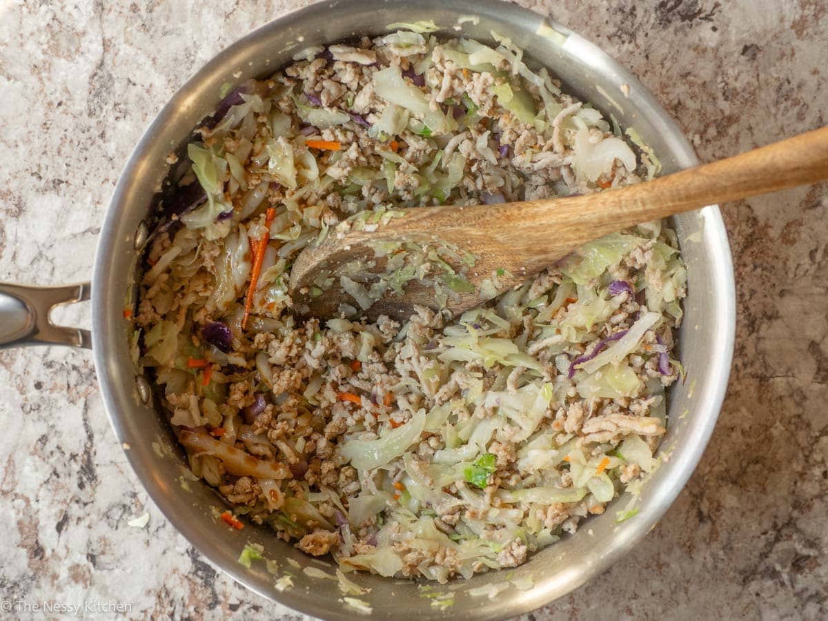 Sauces poured into coleslaw and pork mix.