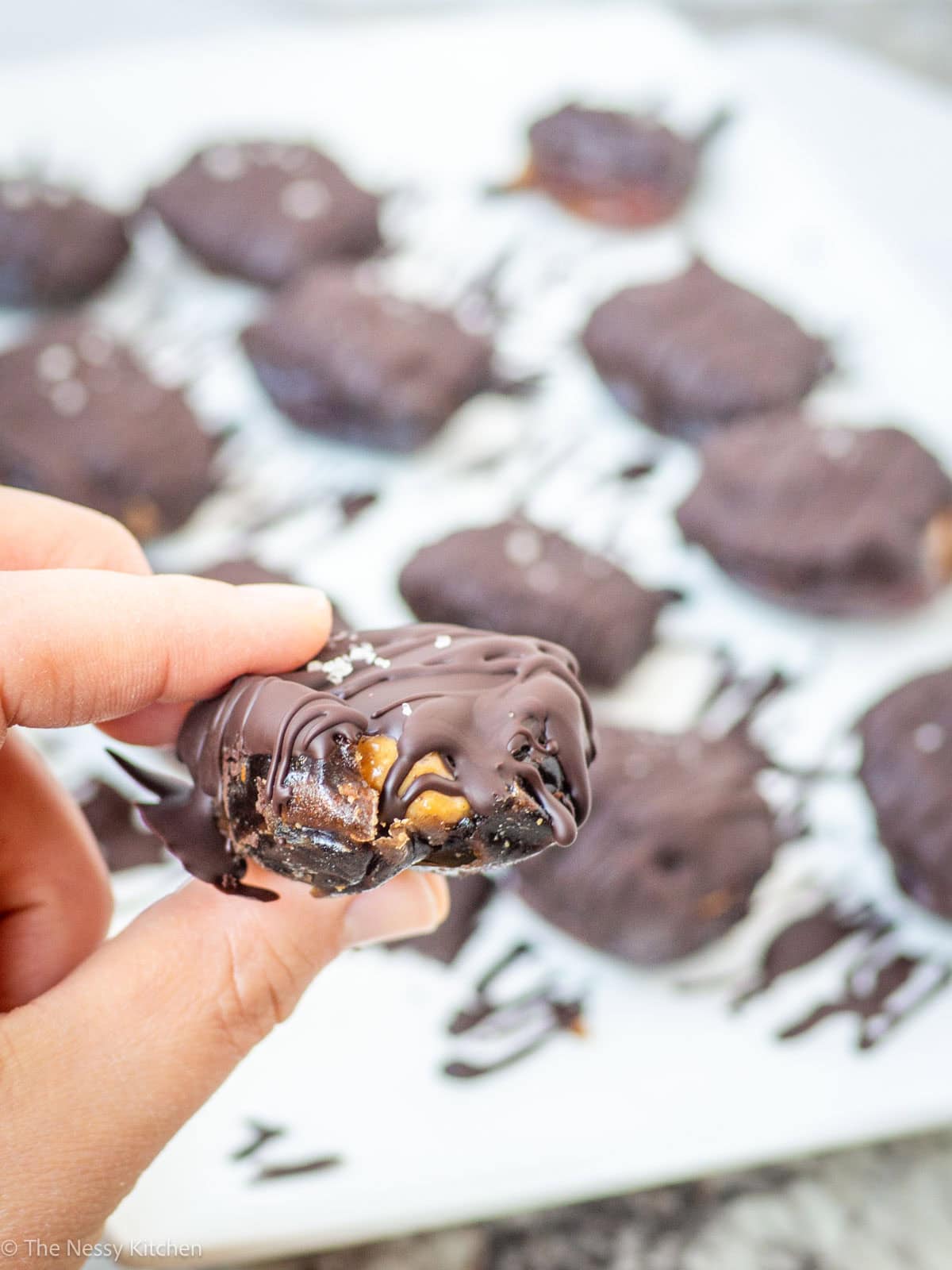 Hand holding a peanut butter date.