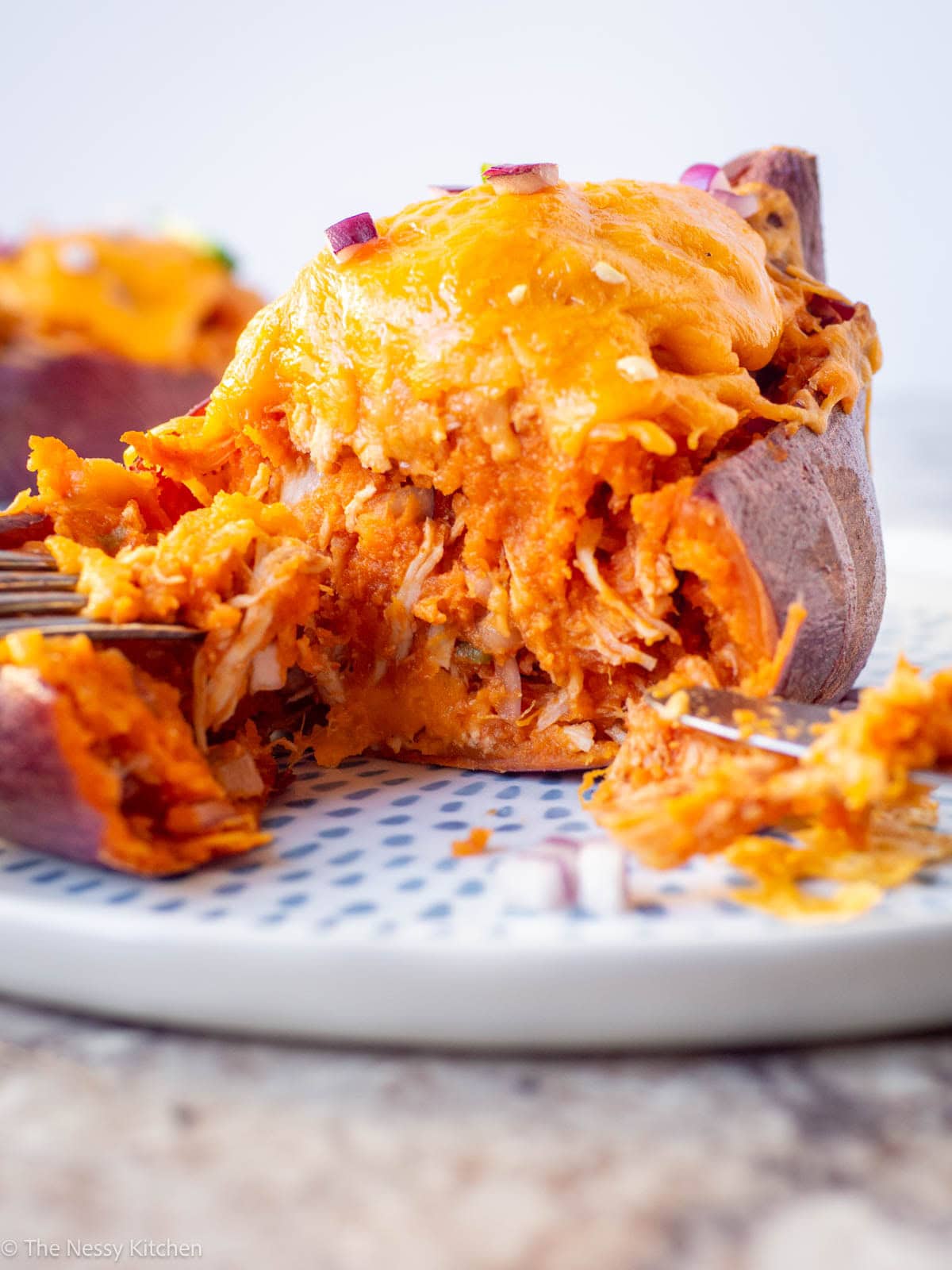 Stuffed sweet potato sliced in half.