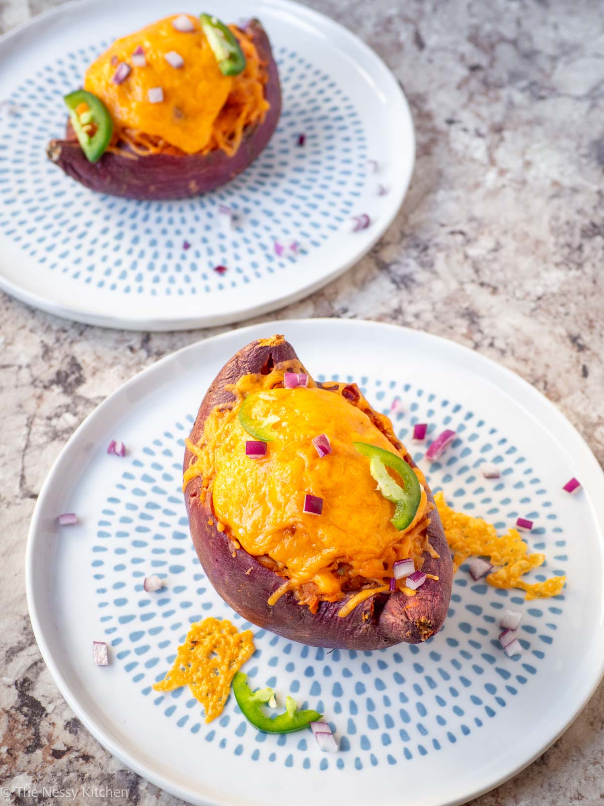 Stuffed sweet potatoes on plates.