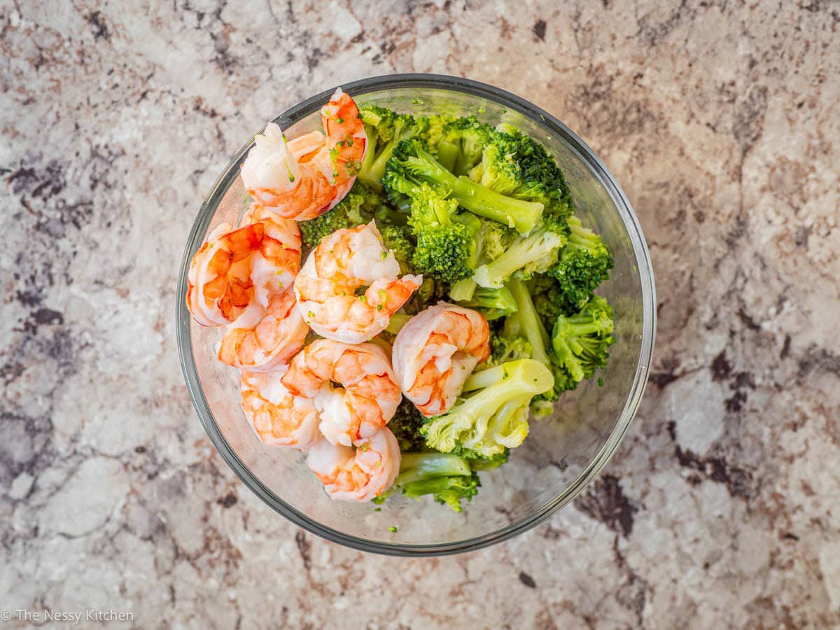 Cooked shrimp and broccoli in a bowl.