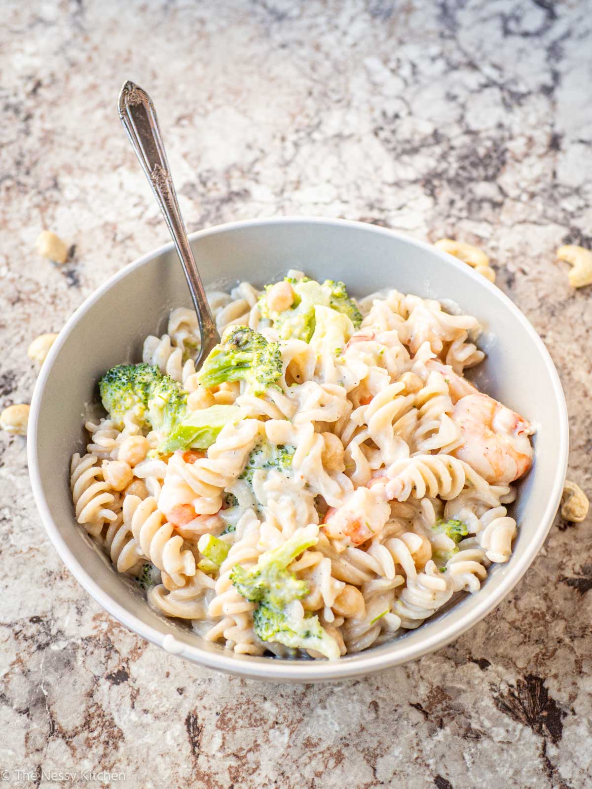 Alfredo Pasta in a bowl with broccoli and shrimp. 