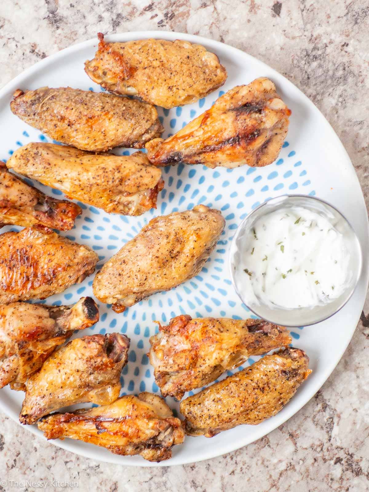 Wings and dip on a plate.