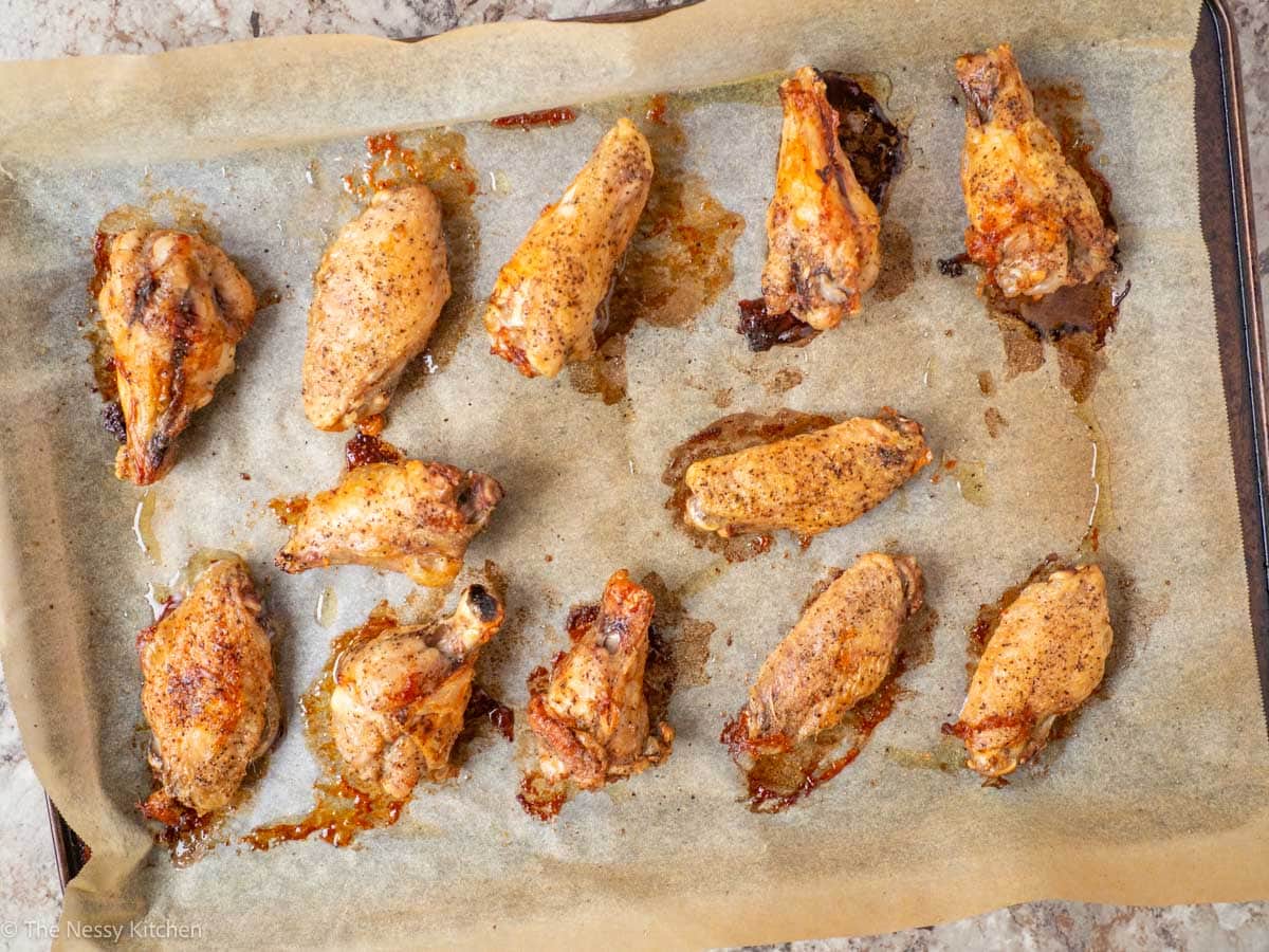 Baked wings on a cookie sheet.