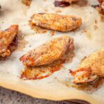 Chicken wings on a baking sheet.