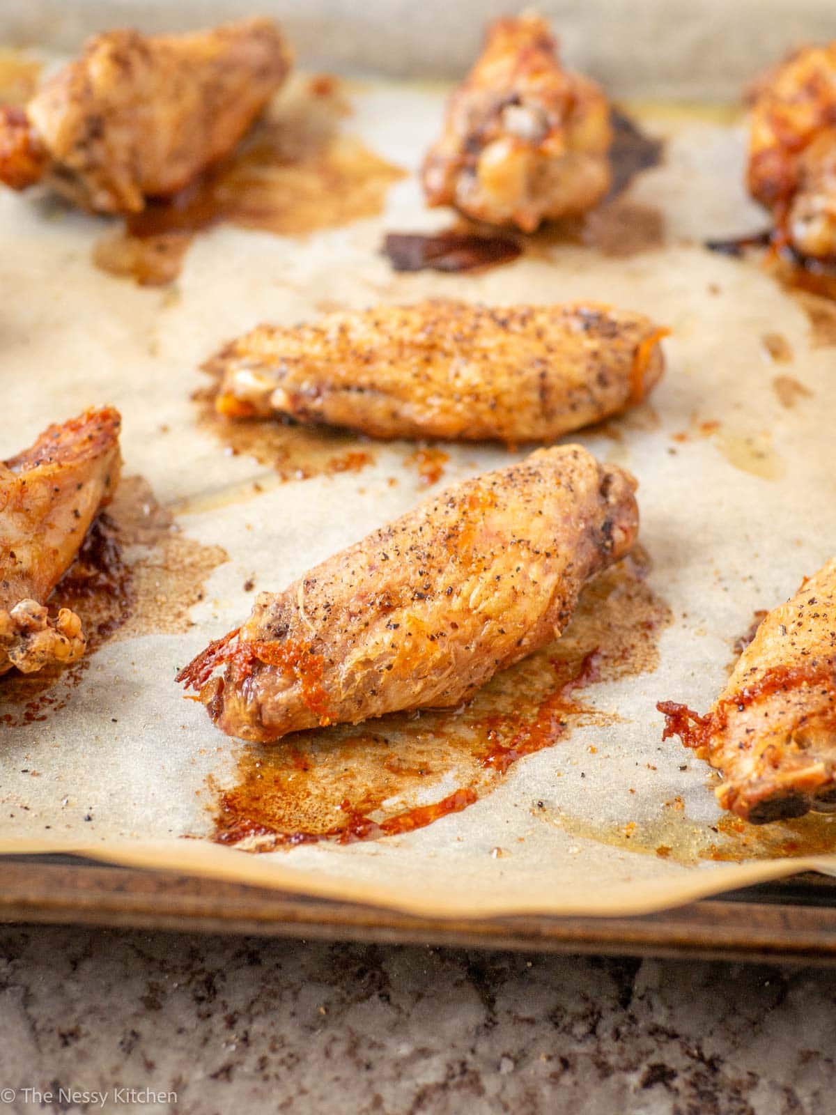 Chicken wings on a baking sheet.