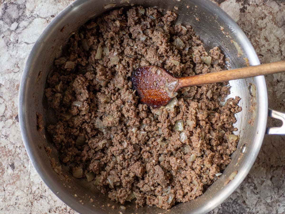 Beef and onions cooked in a pot.