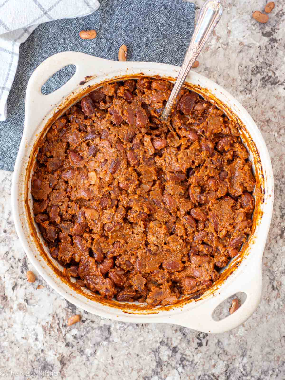 Hamburger baked beans with a serving spoon.