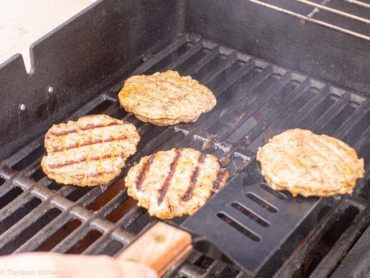 Burgers cooking a grill.