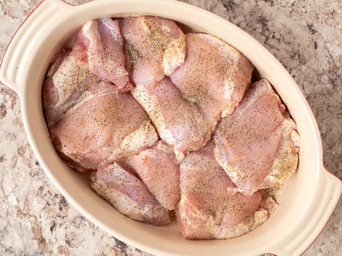Seasoned chicken in a casserole dish.