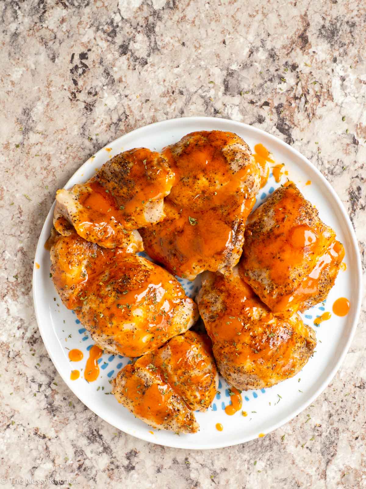 Chicken thighs on a plate.