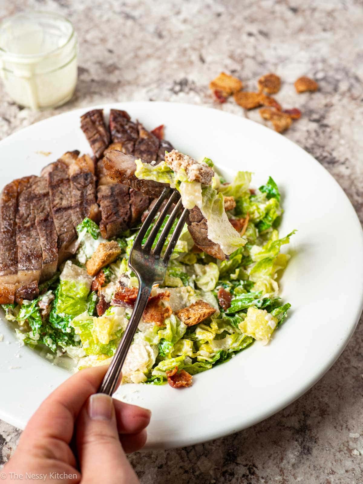 Fork taking a bite of salad.
