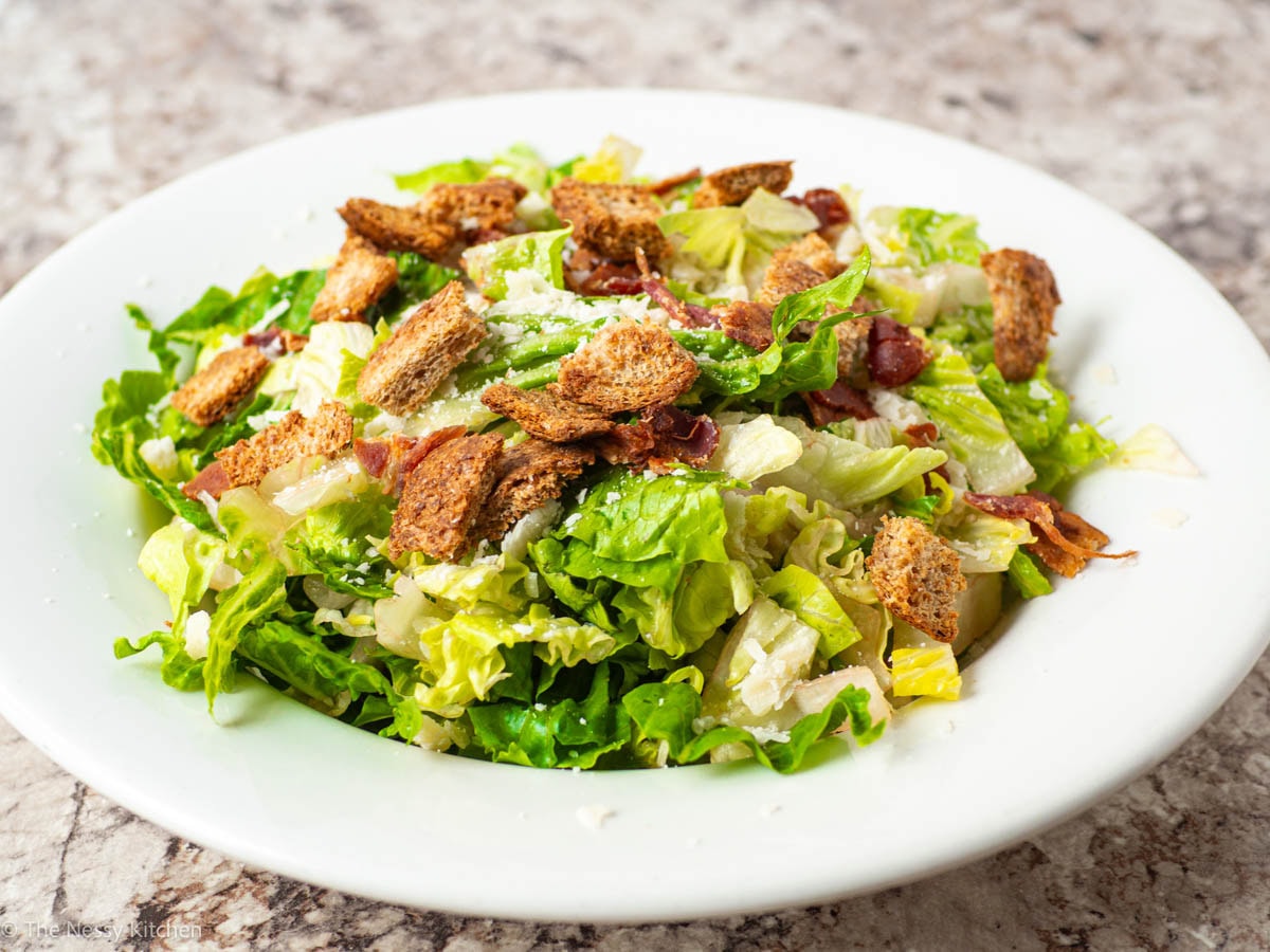 Salad ingredients layered in a bowl.