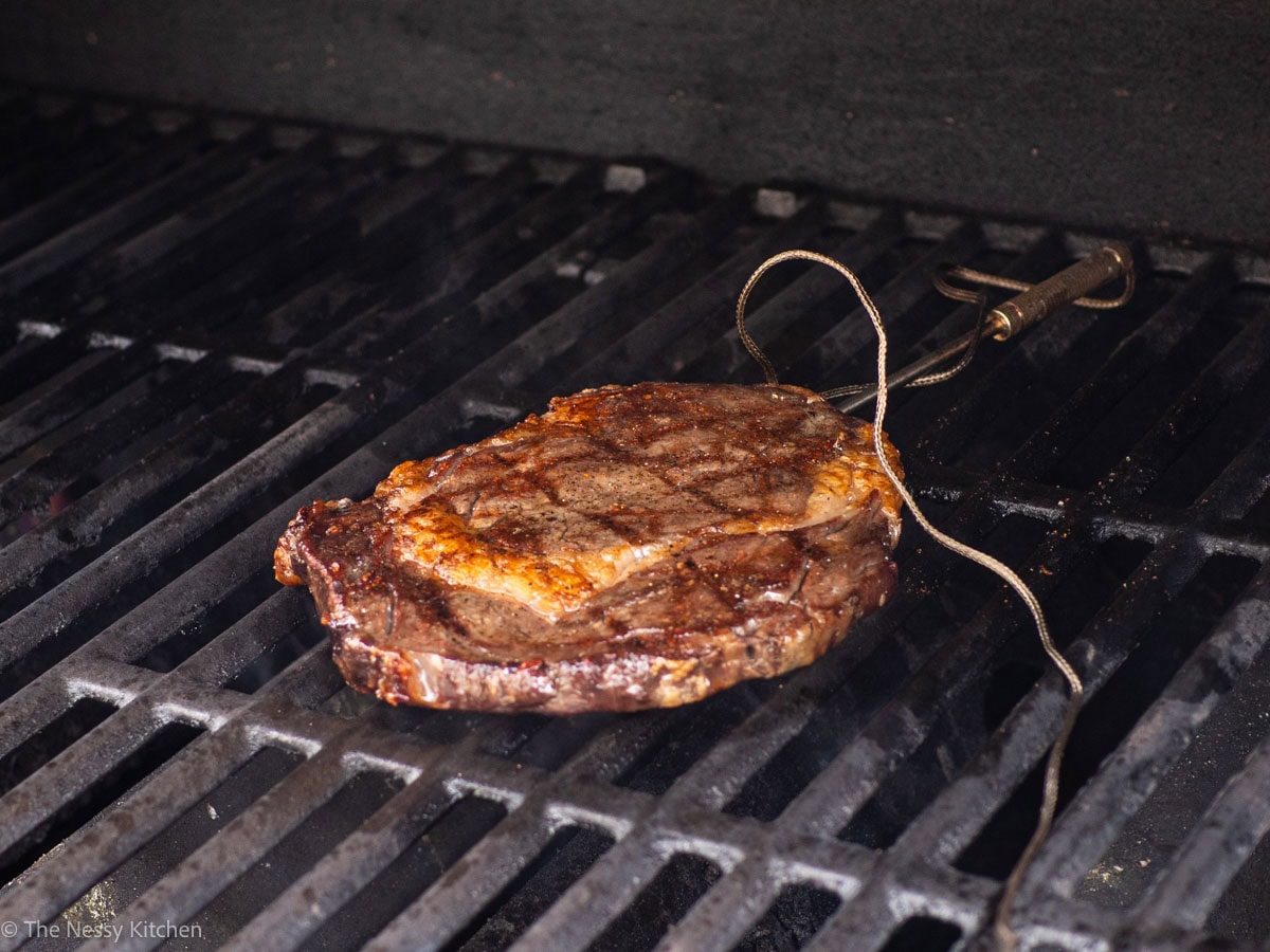 Steak cooking on a barbecue.